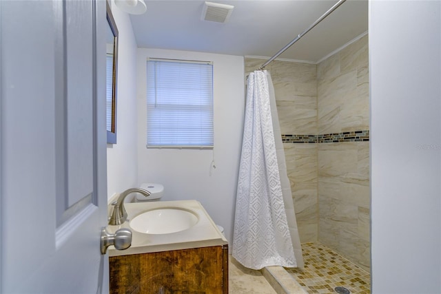 bathroom featuring vanity, toilet, and curtained shower