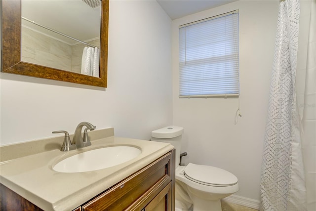 bathroom featuring toilet and vanity