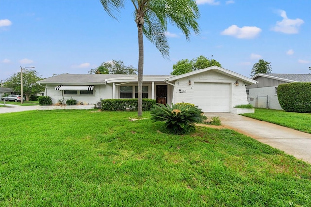 single story home featuring a garage and a front lawn