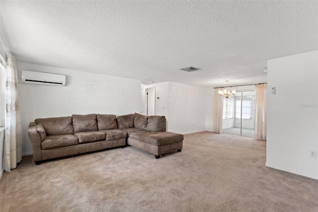 carpeted living room featuring a chandelier, a wall unit AC, and a textured ceiling