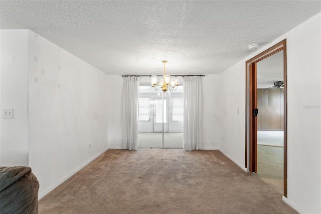 7015 Flaggler Dr, Port Richey, FL 34668 - spare room with an inviting chandelier, carpet, baseboards, and a textured ceiling
