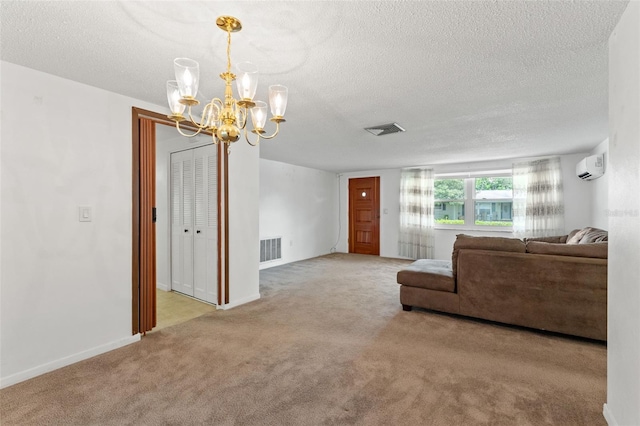 unfurnished living room featuring an inviting chandelier, light carpet, a textured ceiling, and a wall unit AC