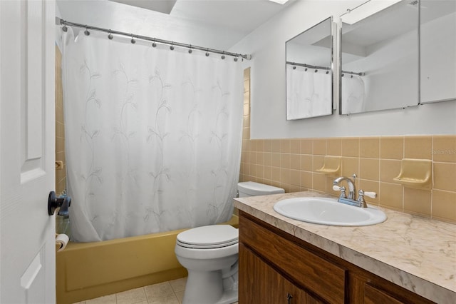 full bathroom with tile walls, tile patterned flooring, vanity, toilet, and shower / bath combo with shower curtain