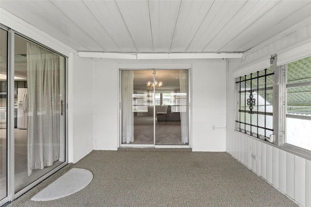 7015 Flaggler Dr, Port Richey, FL 34668 - unfurnished sunroom with a chandelier