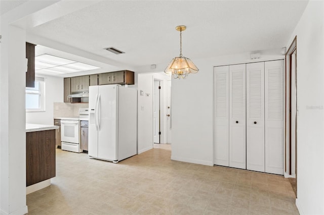 7015 Flaggler Dr, Port Richey, FL 34668 - kitchen with light countertops, visible vents, white appliances, light floors, and under cabinet range hood