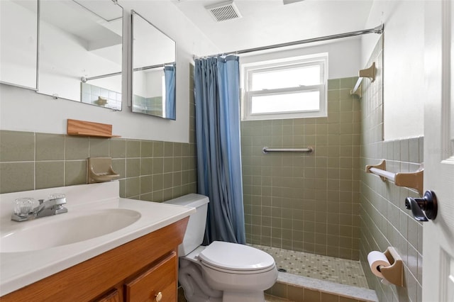 bathroom with a shower with curtain, vanity, tile walls, and toilet