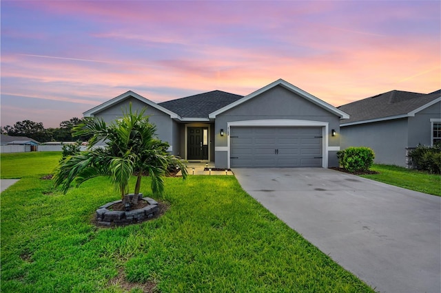 ranch-style house featuring a yard and a garage