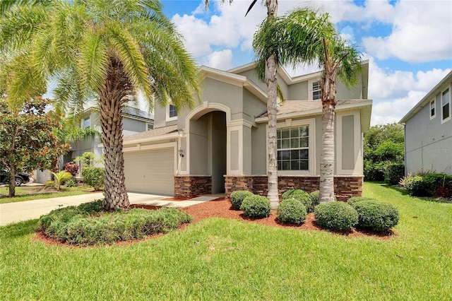 mediterranean / spanish house with a garage and a front yard