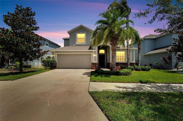 view of front facade featuring a garage and a lawn