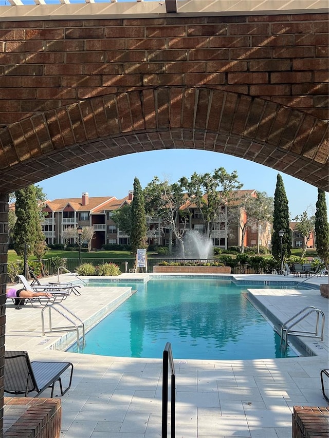 view of swimming pool with a patio area