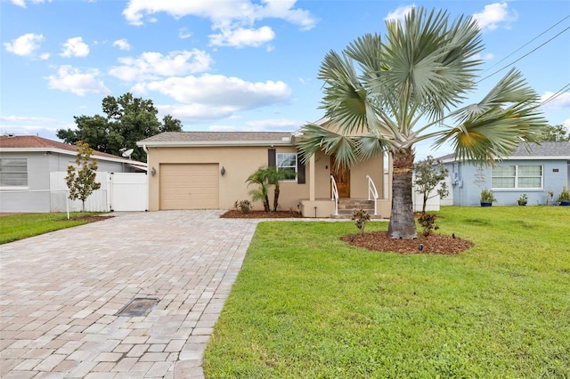 view of front facade featuring decorative driveway, stucco siding, fence, a garage, and a front lawn