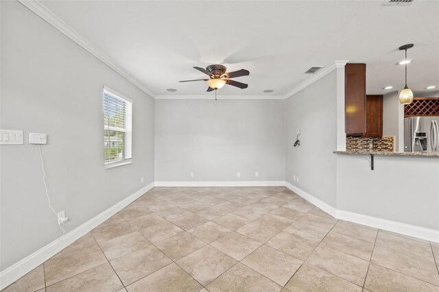 unfurnished room with baseboards, visible vents, a ceiling fan, ornamental molding, and light tile patterned flooring