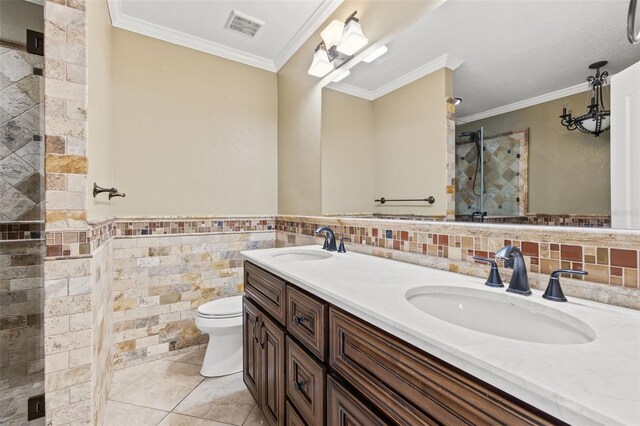 full bath featuring tile walls, a shower stall, visible vents, and a sink