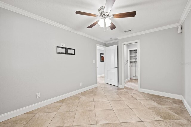 unfurnished room with light tile patterned floors, ornamental molding, visible vents, and baseboards