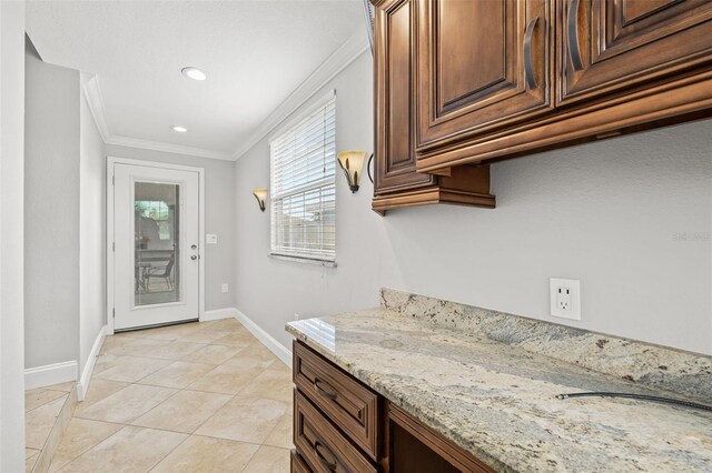 interior space with light tile patterned floors, baseboards, ornamental molding, and recessed lighting