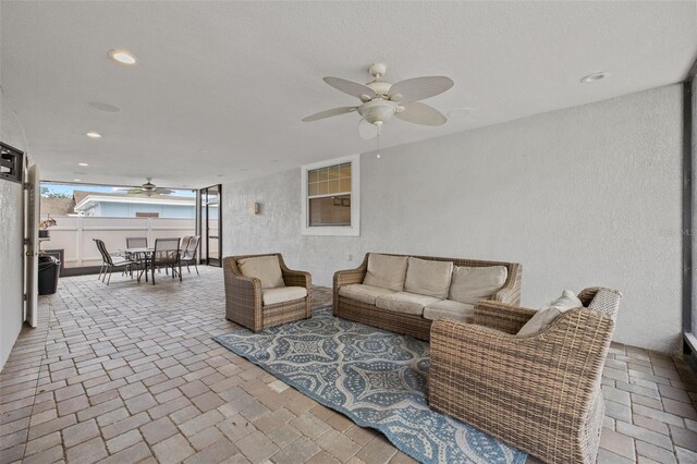 view of patio / terrace with outdoor dining space, ceiling fan, an outdoor living space, and fence