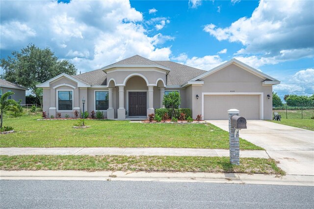 view of front of house with a garage and a front yard