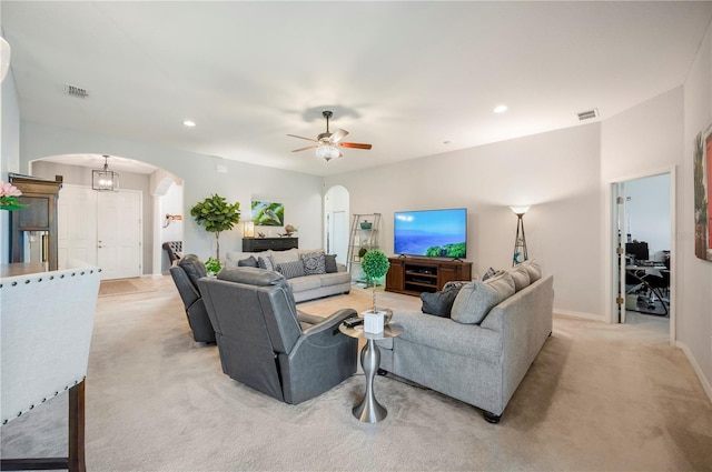 carpeted living room with ceiling fan