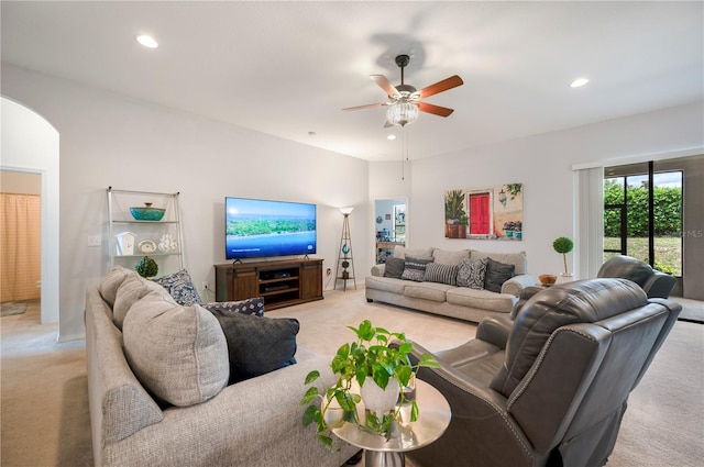 living room featuring light carpet and ceiling fan