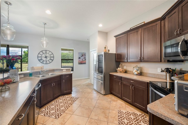 kitchen featuring appliances with stainless steel finishes, light tile patterned flooring, dark brown cabinets, and sink