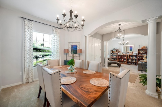 carpeted dining space with ornate columns and a chandelier