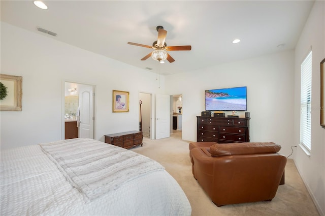 bedroom with ensuite bathroom, ceiling fan, and light colored carpet