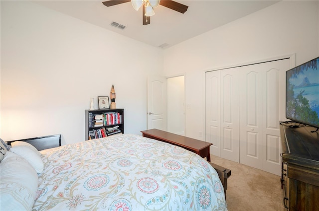 bedroom with a closet, light colored carpet, and ceiling fan