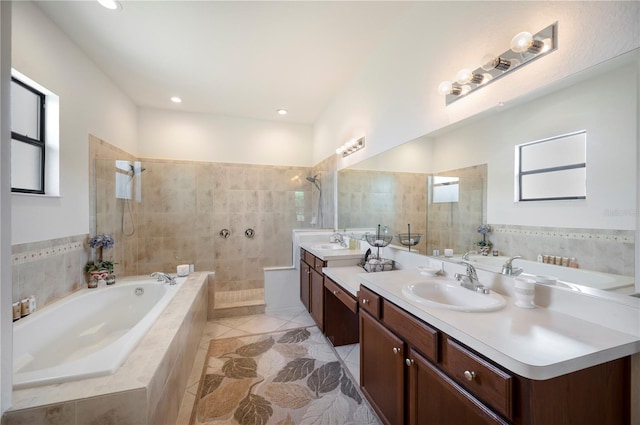 bathroom featuring tile patterned flooring, double vanity, and plus walk in shower