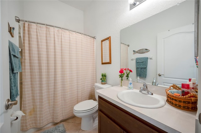 bathroom featuring vanity, toilet, and tile patterned floors