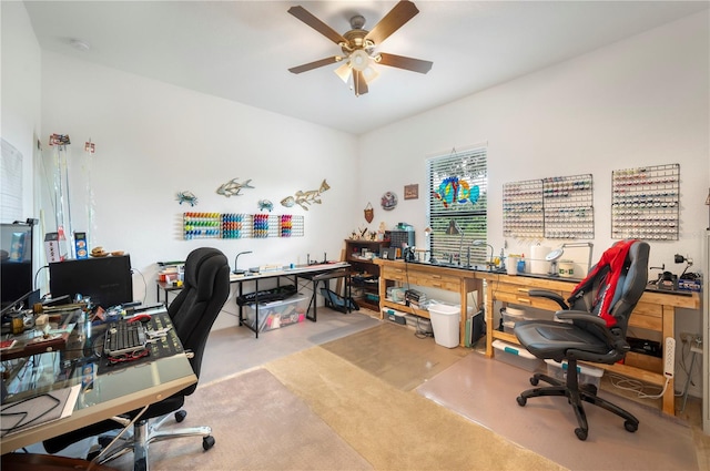 home office featuring light carpet and ceiling fan