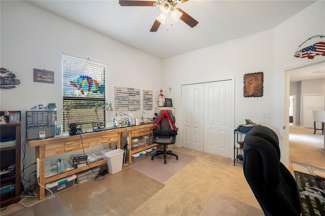 carpeted office space featuring ceiling fan