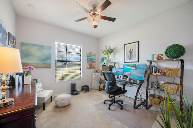 carpeted office space with ceiling fan