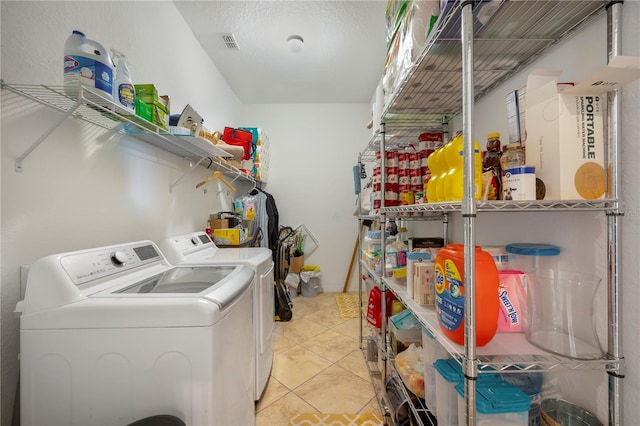 washroom with separate washer and dryer and light tile patterned floors