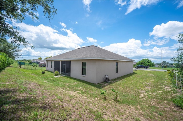 view of side of home featuring a yard