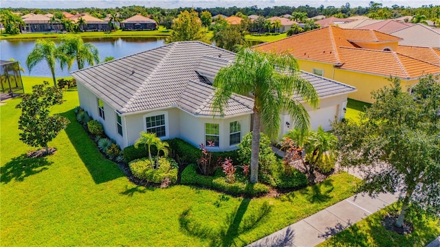 exterior space featuring a water view and a front lawn