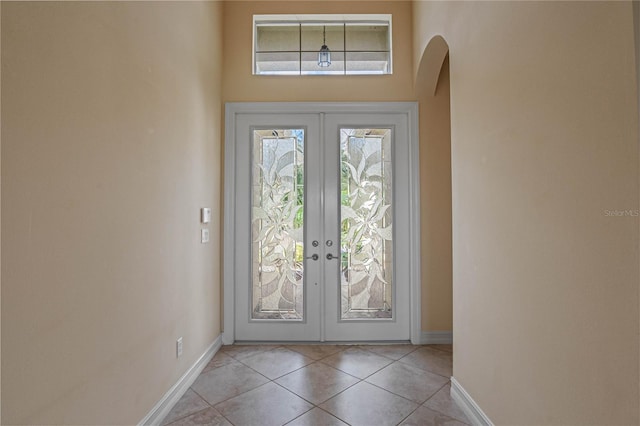 entryway featuring light tile patterned floors and french doors