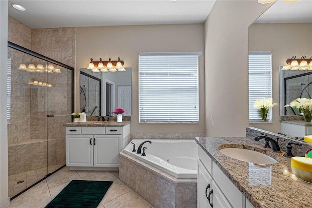 bathroom featuring vanity, independent shower and bath, and tile patterned floors