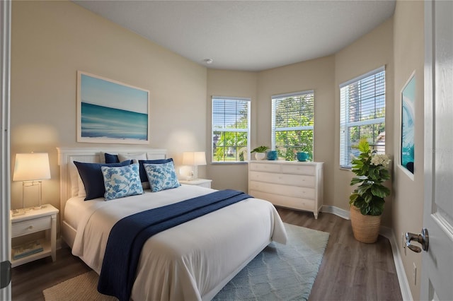 bedroom with dark hardwood / wood-style flooring