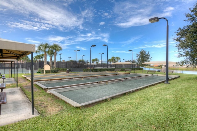 view of community featuring a water view and a lawn