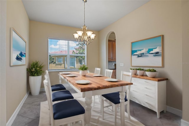 dining space featuring a notable chandelier and light tile patterned flooring