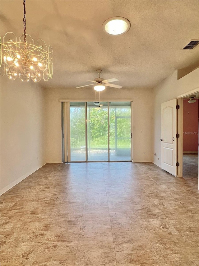 spare room featuring ceiling fan with notable chandelier and a textured ceiling