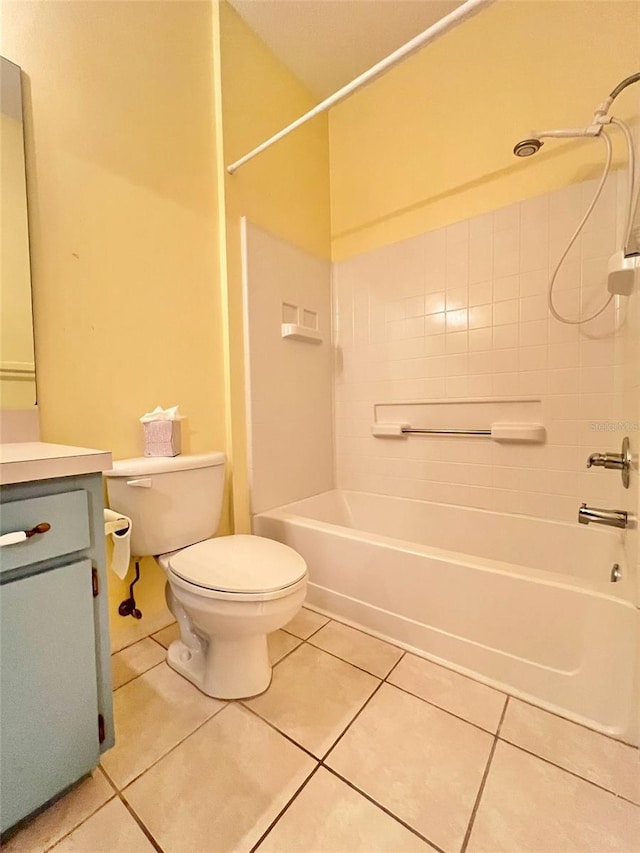 full bathroom with tile patterned floors, toilet, tiled shower / bath combo, and vanity