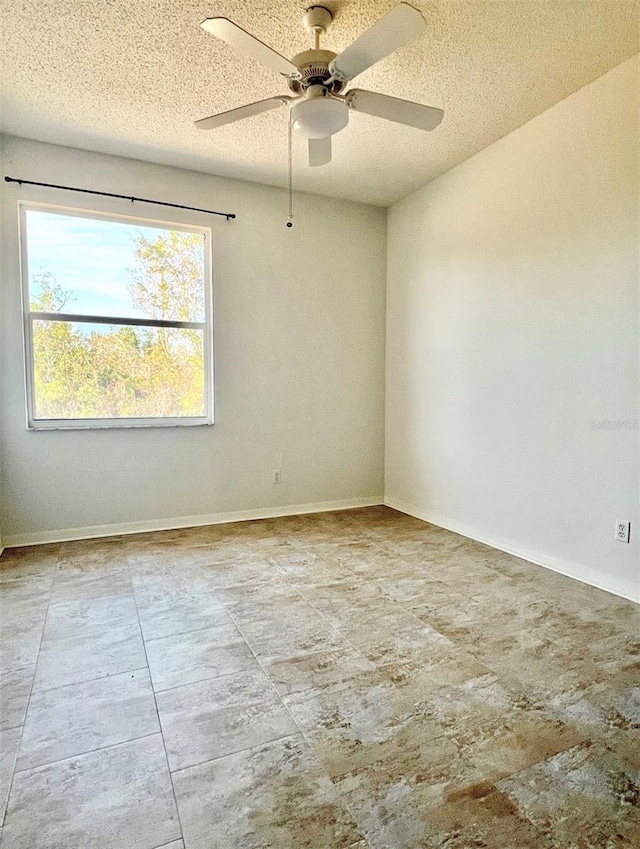 spare room with ceiling fan and a textured ceiling