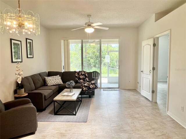761 Tremont Greens Ln Unit 61, Sun City Center, FL 33573 - living area featuring a textured ceiling, ceiling fan, a chandelier, baseboards, and light tile patterned floors