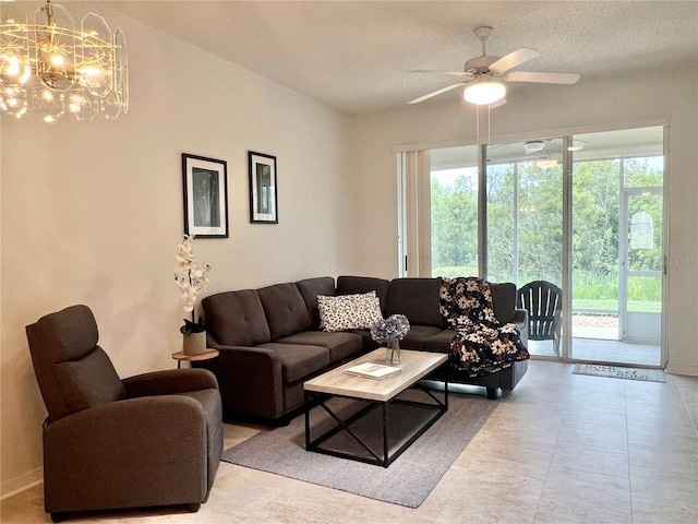 761 Tremont Greens Ln Unit 61, Sun City Center, FL 33573 - living room with a textured ceiling, baseboards, and ceiling fan with notable chandelier