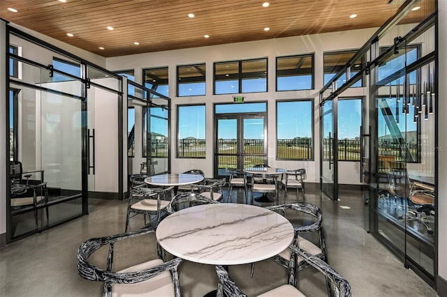 sunroom featuring wooden ceiling and french doors