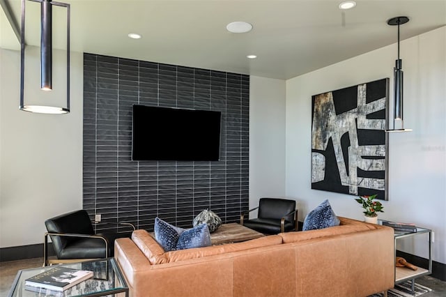 living room featuring baseboards and recessed lighting