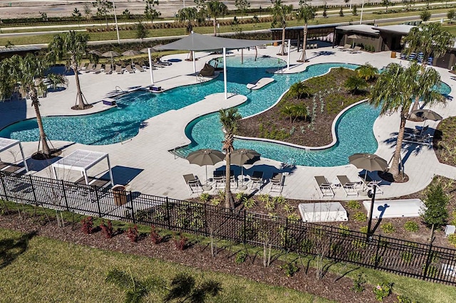 view of swimming pool featuring a patio area and fence