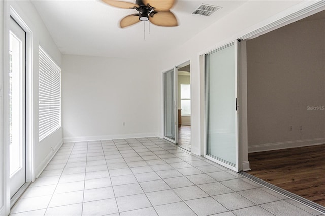 empty room with light wood-type flooring and ceiling fan