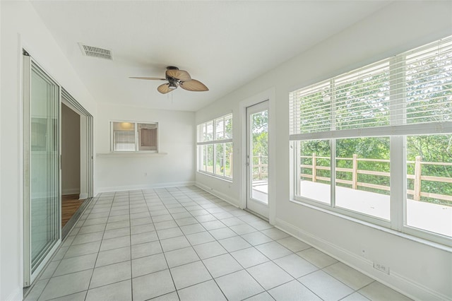 unfurnished sunroom with ceiling fan